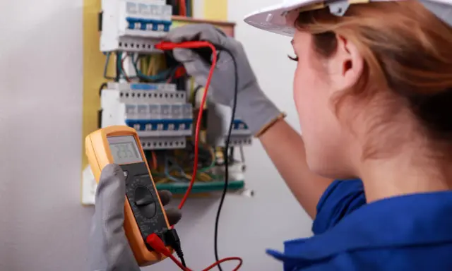Elektryk sprawdza instalację multimetrem. Dowiedz się, ile kosztują pomiary elektryczne.